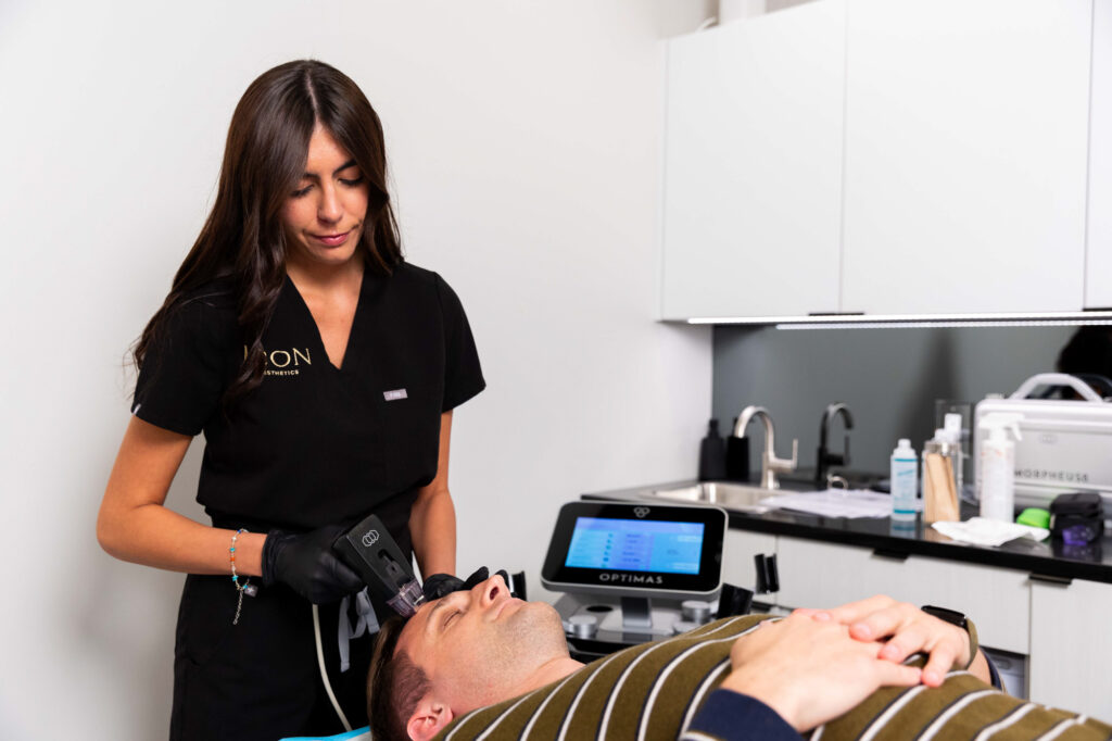 A patient lays on a treatment table while undergoing a skin tightening in Valparaiso treatment using RF Microneedling.